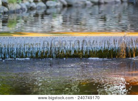 Cold Transparent Water Of Decorative Artificial Waterfall In Summer Park.