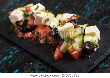 Greek salad with feta cheese cubes and fresk vegetables