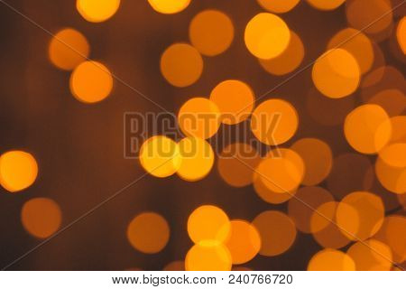 Many Blurred Small Electric Bulbs On A Wall. Yellow Blurred Lights. Wall Of Christmas Lights