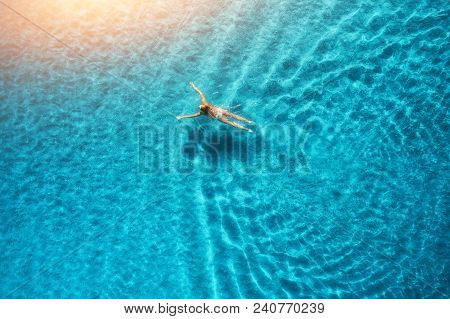 Aerial View Of Swimming Woman In Mediterranean Sea At Sunset