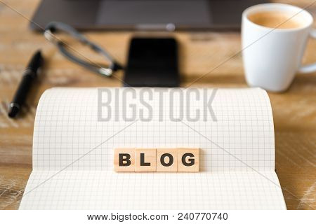 Closeup On Notebook Over Wood Table Background, Focus On Wooden Blocks With Letters Making Blog Word