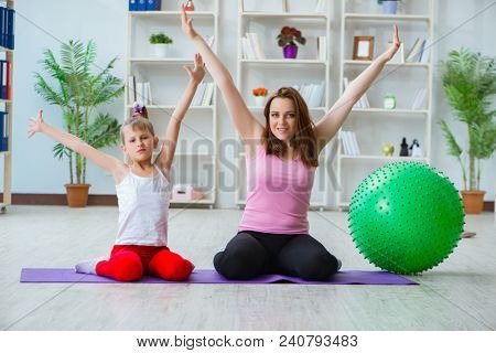 Girl and mother exercising at home