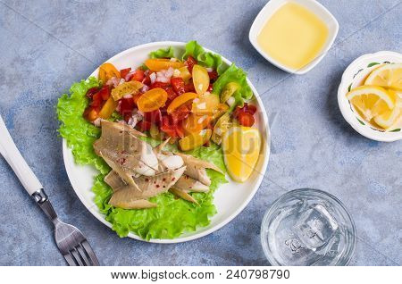 Fish Fillet With Raw Vegetables And Lemon In A Dish On The Table. Selective Focus.