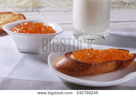 Morning Breakfast Set With Orange Jam On Bread Toast And Milk In Glass