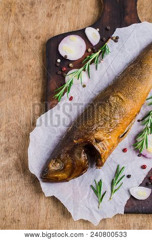 Smoked Whole Fish With Spices On Wooden Background. Selective Focus.