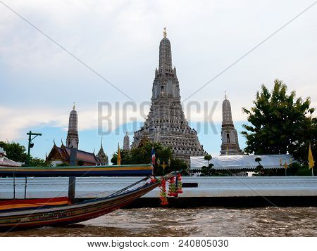 Temple Wat Arun In Bangkok With Boat On The River