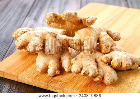 Spicy Root Of Ginger On A Wooden Table