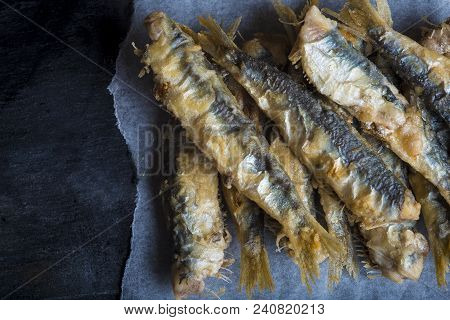 Fried Sardines On A Slate Background
