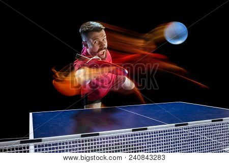 The Table Tennis Player In Motion. Fit Young Sports Man Tennis-player In Play On Black Background Wi