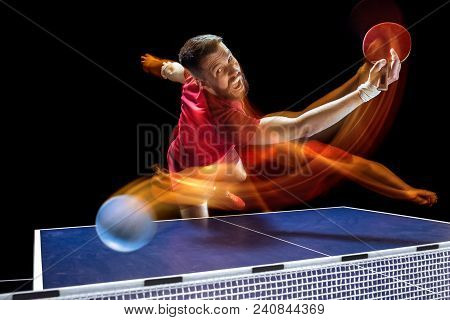 The Table Tennis Player In Motion. Fit Young Sports Man Tennis-player In Play On Black Background Wi