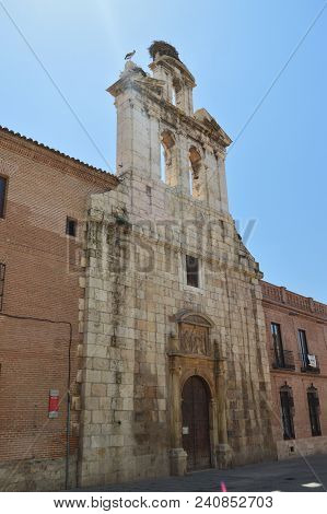 Beautiful Front Facade Of The Church Of Alcala De Henares University With A Nest Of Storks In Its Ol
