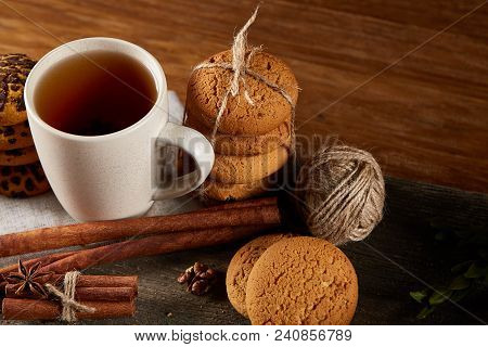Traditional Christmas Tea Concept With A Cup Of Hot Tea, A Large Set Of Cookies On A Homespun Napkin