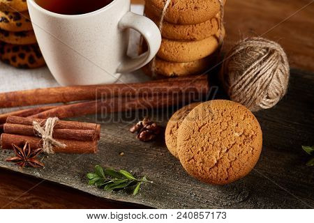 Traditional Christmas Tea Concept With A Cup Of Hot Tea, A Large Set Of Cookies On A Homespun Napkin