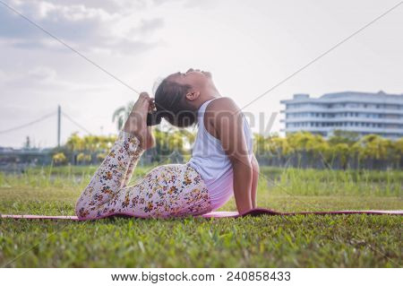 Healthy Yoga Girls And Concentrate In The Park , Kid Yoga Practice For Health In The Nice Day , Yoga