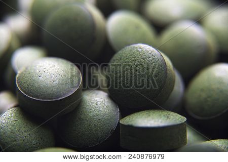 Close Up Of Many Spirulina Tablets With Low Depth Of Field. Horizontal Image.