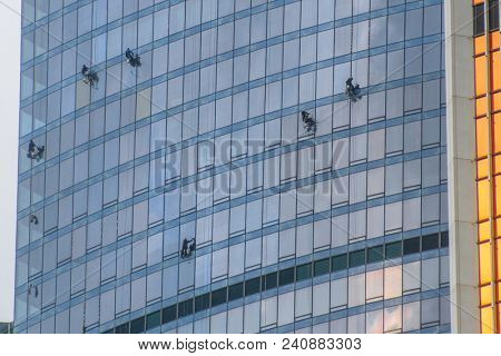 Moscow, Russia - May, 13, 2018: Steeplejacks work on a wall of Moscow city building
