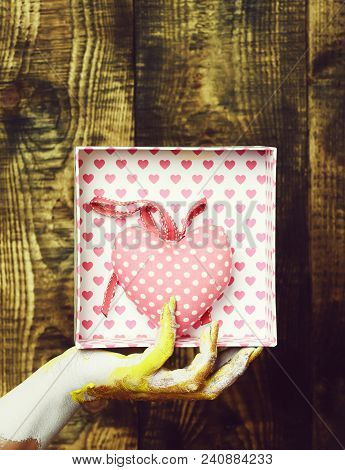 Female Hand Smeared In Golden Paint Or Glister Holding Handmade Pink Polka Dots Valentine Heart In P