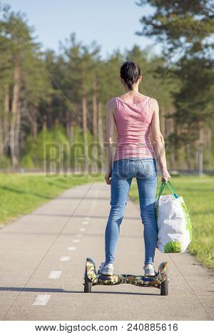 Young Woman On Hover Board. Girl Riding Hover Board In Summer Park. Balance Board For Adult.