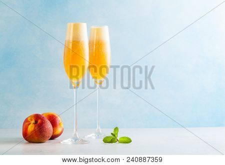 Two Glasses Of Champagne With A Cocktail Of Bellini And Fresh Pe