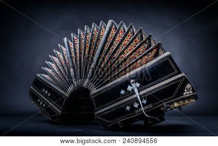 Close Up Of An Bandoneon Against A Black Background
