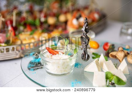 Grated Parmesan Cheese In Glass Cup In A Restaurant