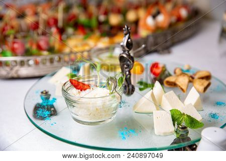Grated Parmesan Cheese In Glass Cup In A Restaurant