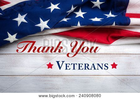 American Flag On A White Worn Wooden Background With Veteran's Day Greeting