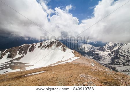 One Of The Snow-capped Peaks Of Mount Oshten, Under A Cloudy Sky