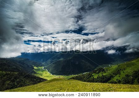 River Valley Among High Mountains In Storm
