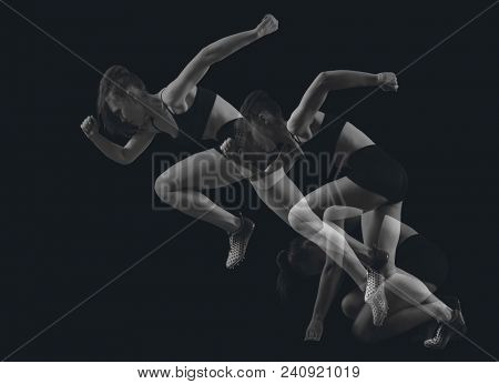 Woman sprinter leaving starting blocks on the athletic track. Double Exposure
