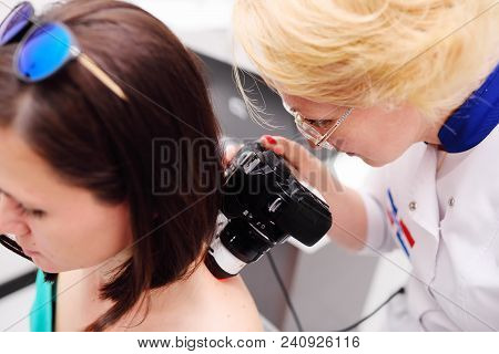 The Doctor Examines The Patient's Mole