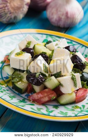 Greek salad with feta cheese cubes and fresk vegetables