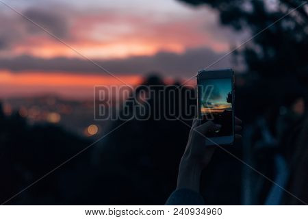 Young Woman Taking Photo With Her Phone