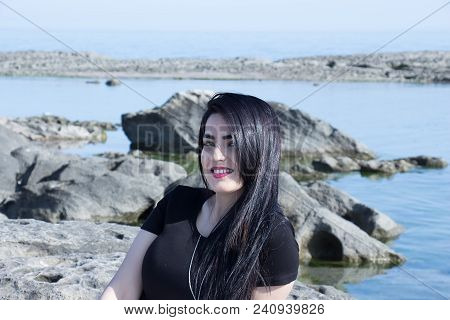 Happy Woman On The Beach. Portrait Of A Beautiful Girl Close-up. Spring Portrait On The Beach. Young