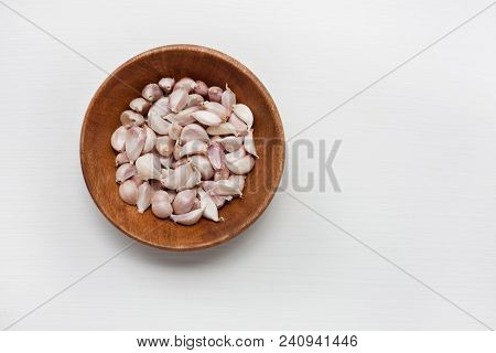 Garlic In Wooden Bowl Isolated On White .  Copy Spce