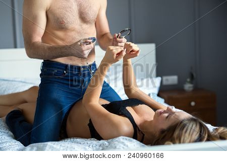 Attractive Sexy Woman With Her Handsome Partner In Bedroom
