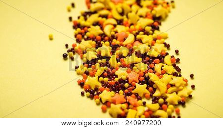 Colorful Nonpareil On Yellow Background. Selective Focus