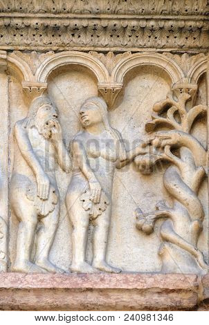 MODENA, ITALY - JUNE 04: Plate with stories from Genesis: Temptation, relief by Wiligelmo, Modena Cathedral, Italy on June 04, 2017.
