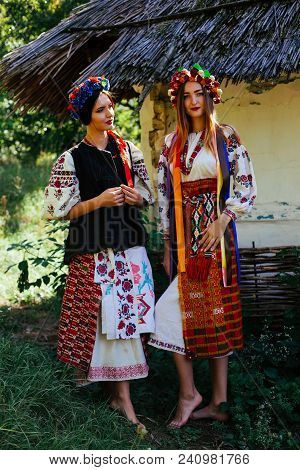 Two Beautiful Ukrainian Girl  Blond And Brunette In National Embroidered Clothes On A Background Of 