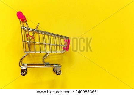 Small Supermarket Grocery Push Cart For Shopping Toy With Wheels And Pink Plastic Elements On Yellow