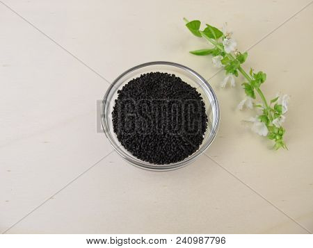 Superfood Basil Seeds And Basil Flower On Wooden Board