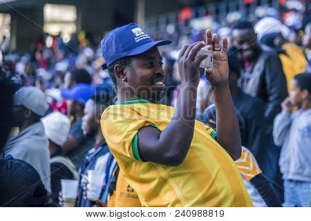 Cape Town, South Africa, 12 May 2018 - Diverse South African Football Supporter Taking A Photograph 