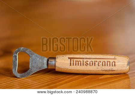 Valiug, Romania - April 08, 2018: Timisoareana Beer Bottle Opener On A Wooden Table. Copy Space.