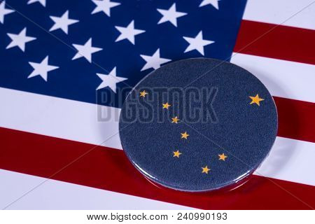 London, Uk - April 27th 2018: The Symbol Of The State Of Alaska, Pictured Over The Flag Of The Unite