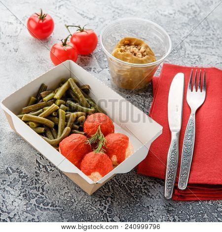 Boiled String Beans, Fish Balls In Sauce And Baked Apple In Lunchbox On A Gray Background. Healthy F