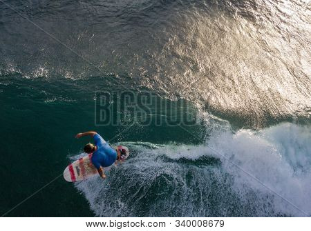 OAHU, HI / USA - NOVEMBER 15,2018: Surfer rides the ocean wave