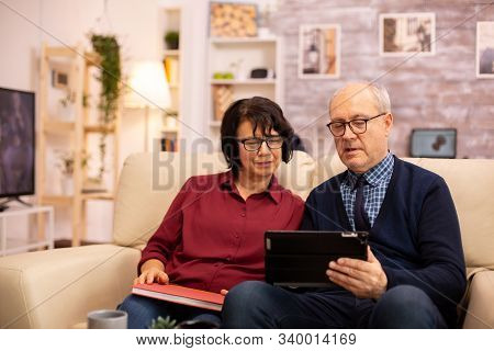 Beautiful Old Couple Using A Digital Tablet To Chat With Their Family