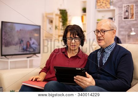 Beautiful Old Couple Using A Digital Tablet To Chat With Their Family
