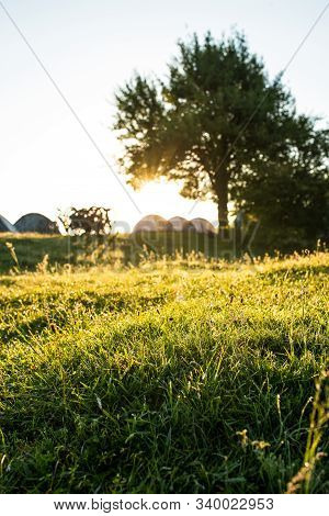 Morning In The Camp With Tents And Bycicles On Background