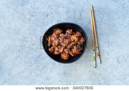 Asian Food Homemade Chinese General Tsos Chicken With Sesame Seeds Served With Chopsticks. Tradition